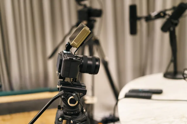 Close-up of a camera and microphone in a professional podcast studio, highlighting equipment setup. Finding and assessing UGC creators